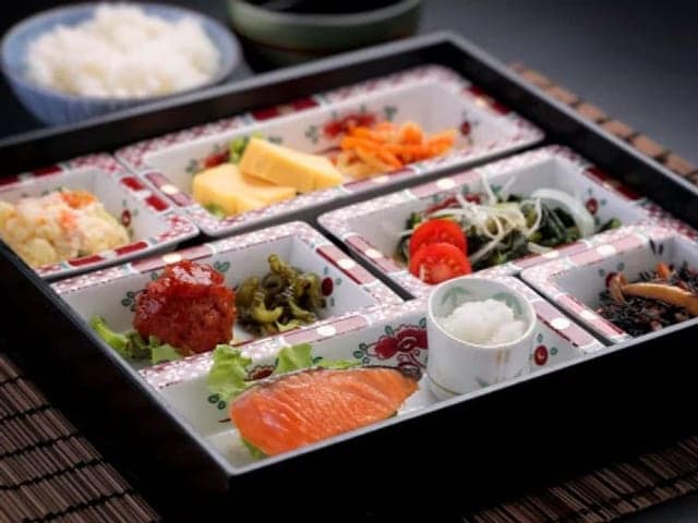 和風の朝食。仕切りの器に焼き魚と小鉢、刺身が並ぶ