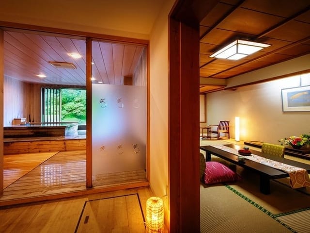 展望風呂付きの客室。障子の奥に源泉かけ流しの湯船が見える