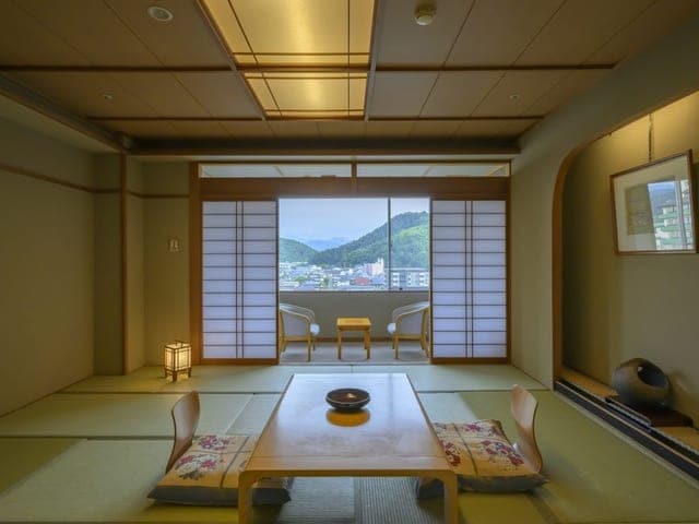 和室。障子を開けた窓の先に山並みが見える